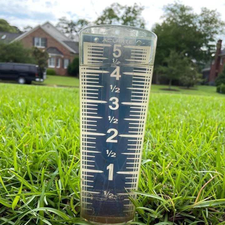 A photograph of a backyard rain gauge with more than 4 inches of water in it.
