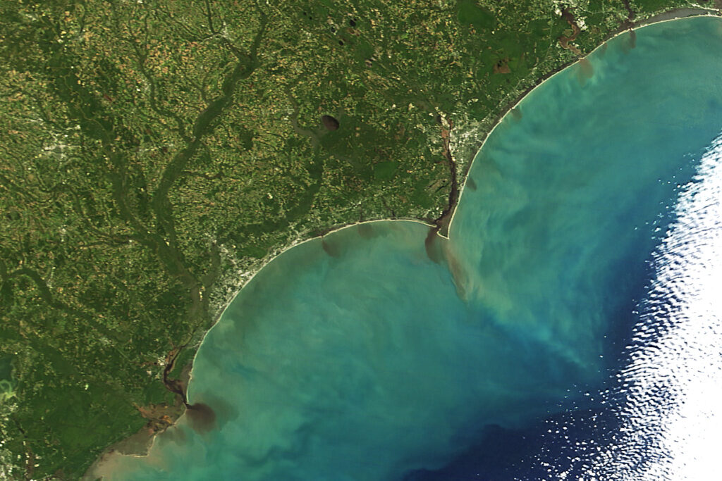 A satellite image of sediment from the Cape Fear River reaching the Atlantic Ocean