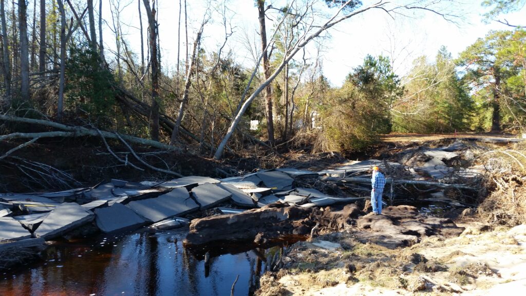A photo of a flooded and washed-out roadway after Matthew