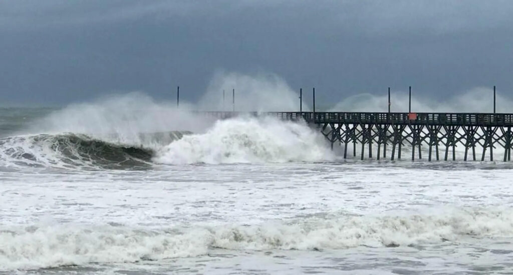 A photo of waves crashing at the Surf City pier