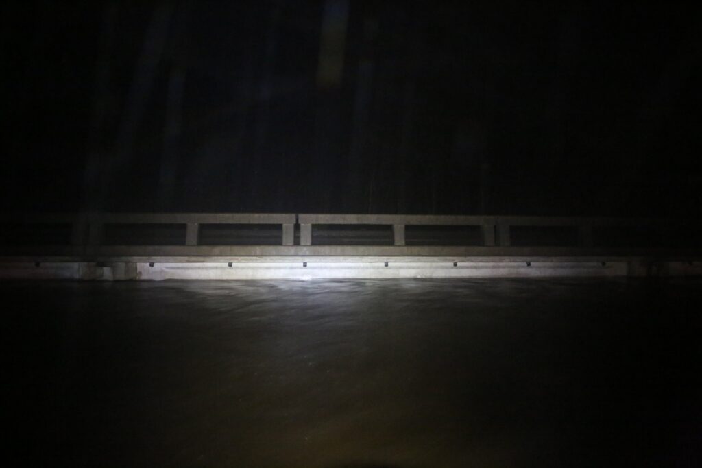 A photo of water up to the bridge level on Highway 70 near Newport