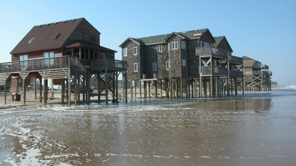 A photo of the ocean reaching the base of homes in Rodanthe after Isabel