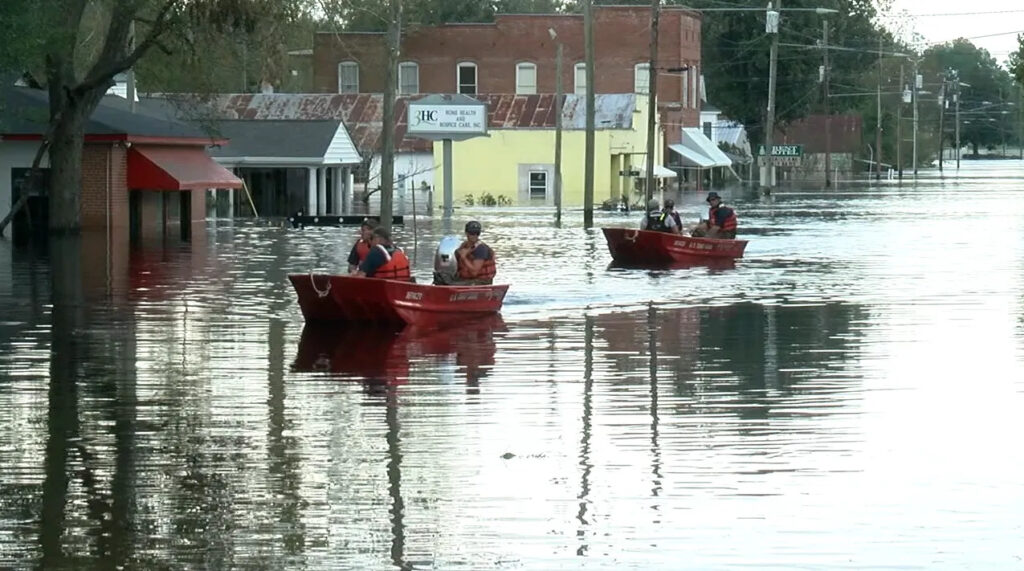 A photo of boats riding through flooded downtown Pollocksville after Hurricane Florence