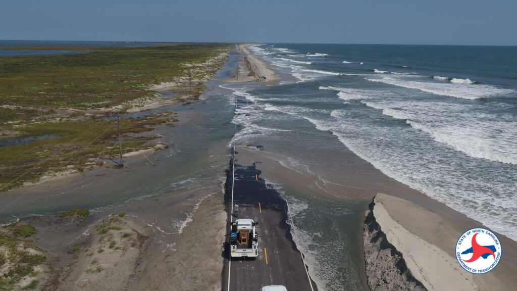 A photo of NCDOT trucks at a breach of Highway 12 on Ocracoke Island after Hurricane Dorian