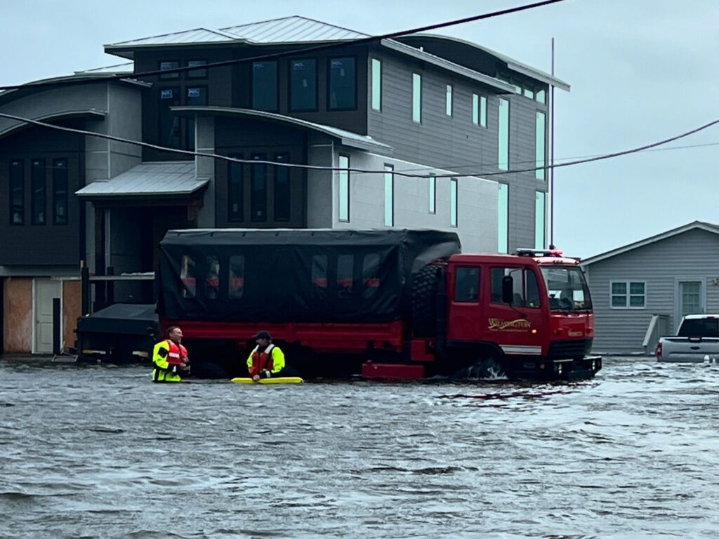 A photo of Wilmington Fire Department rescue crews with their rescue vehicle on the water.