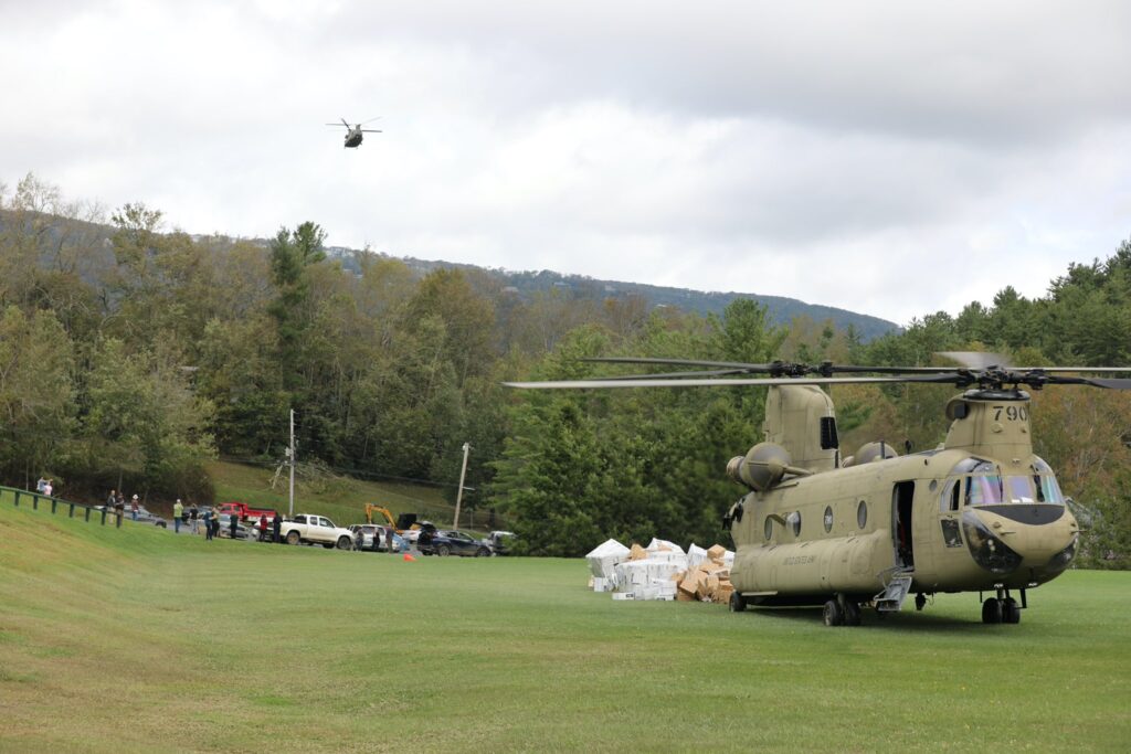 A photo of National Guard helicopters delivering food and water to Avery County