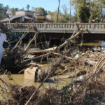 A photo of debris along the Swannanoa River in Biltmore Village following Hurricane Helene