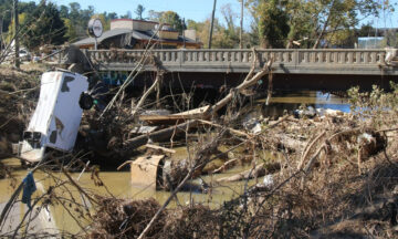 A photo of debris along the Swannanoa River in Biltmore Village following Hurricane Helene