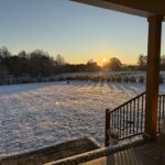 A photo of snow covering the ground with the sun rising in the skies on December 3, 2024