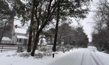 A photo of snow on the ground at the Currituck Beach Light Station on February 19