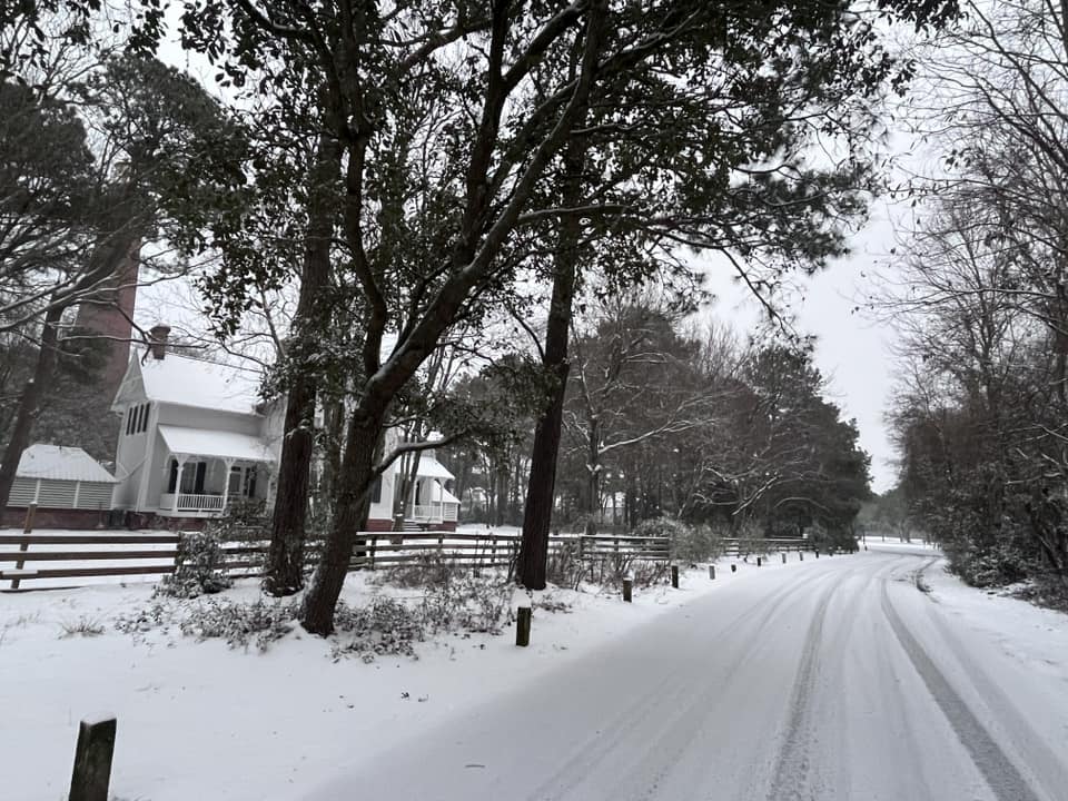 A photo of snow on the ground at the Currituck Beach Light Station on February 19