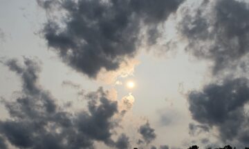 A photo of the sun in a hazy, cloudy sky over the Outer Banks on June 1