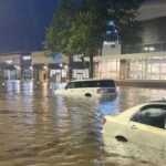 A photo of cars in deep flood waters at a shopping center in Chapel Hill after Tropical Storm Chantal