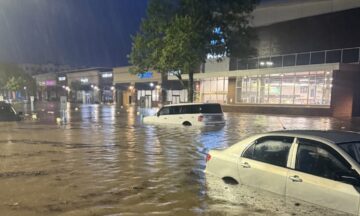 A photo of cars in deep flood waters at a shopping center in Chapel Hill after Tropical Storm Chantal