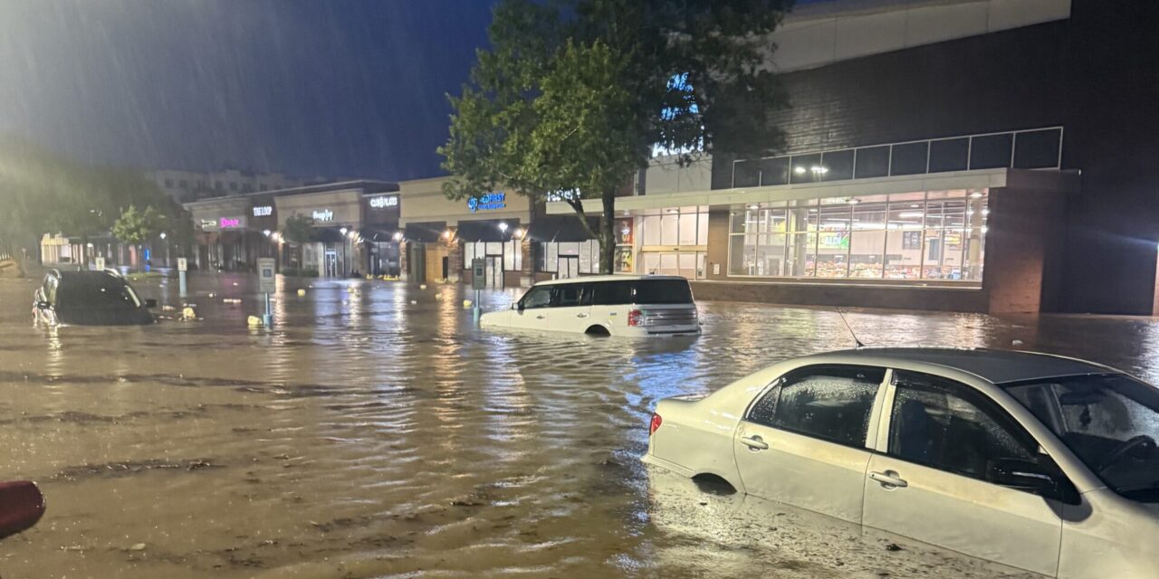 A photo of cars in deep flood waters at a shopping center in Chapel Hill after Tropical Storm Chantal