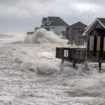 A photo of waves crashing into homes in Buxton during Hurricane Erin