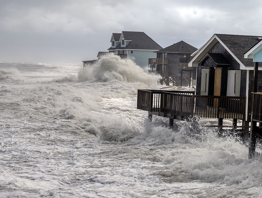 A photo of waves crashing into homes in Buxton during Hurricane Erin