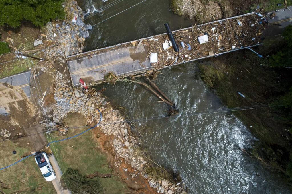 An aerial photo of damage and debris on a bridge over the Pigeon River in Bethel, NC, after Tropical Storm Fred