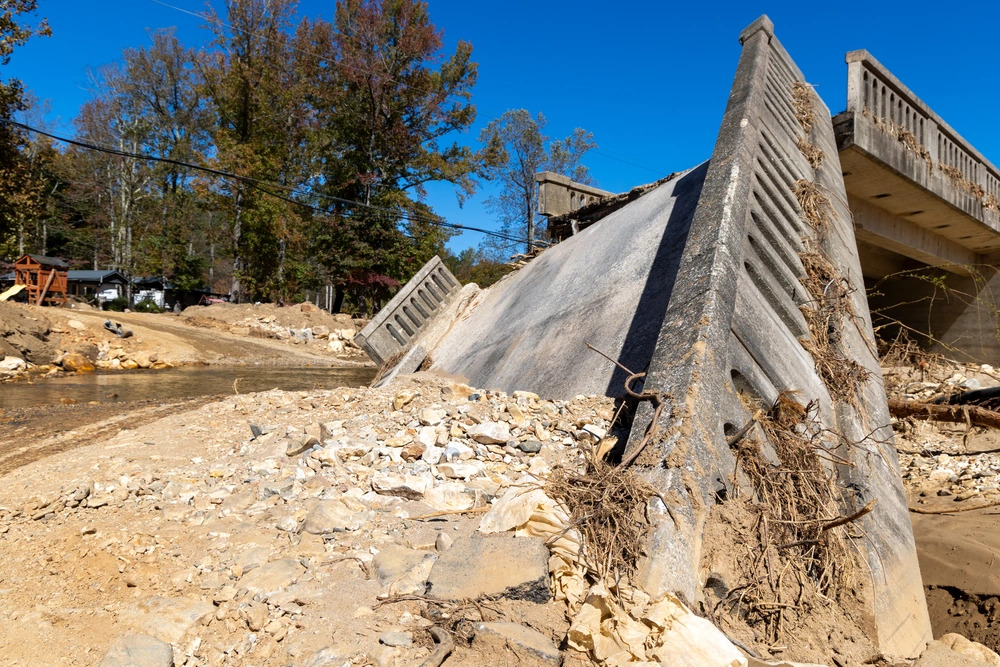 A photo of a damaged bridge in Marion, NC, over the North Fork Catawba River following Hurricane Helene